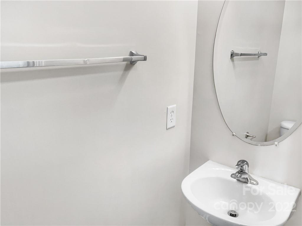 6156 Prosperity Church Road Charlotte, NC 28269 - Photo 21 of 31 a bathroom with a sink and a mirror