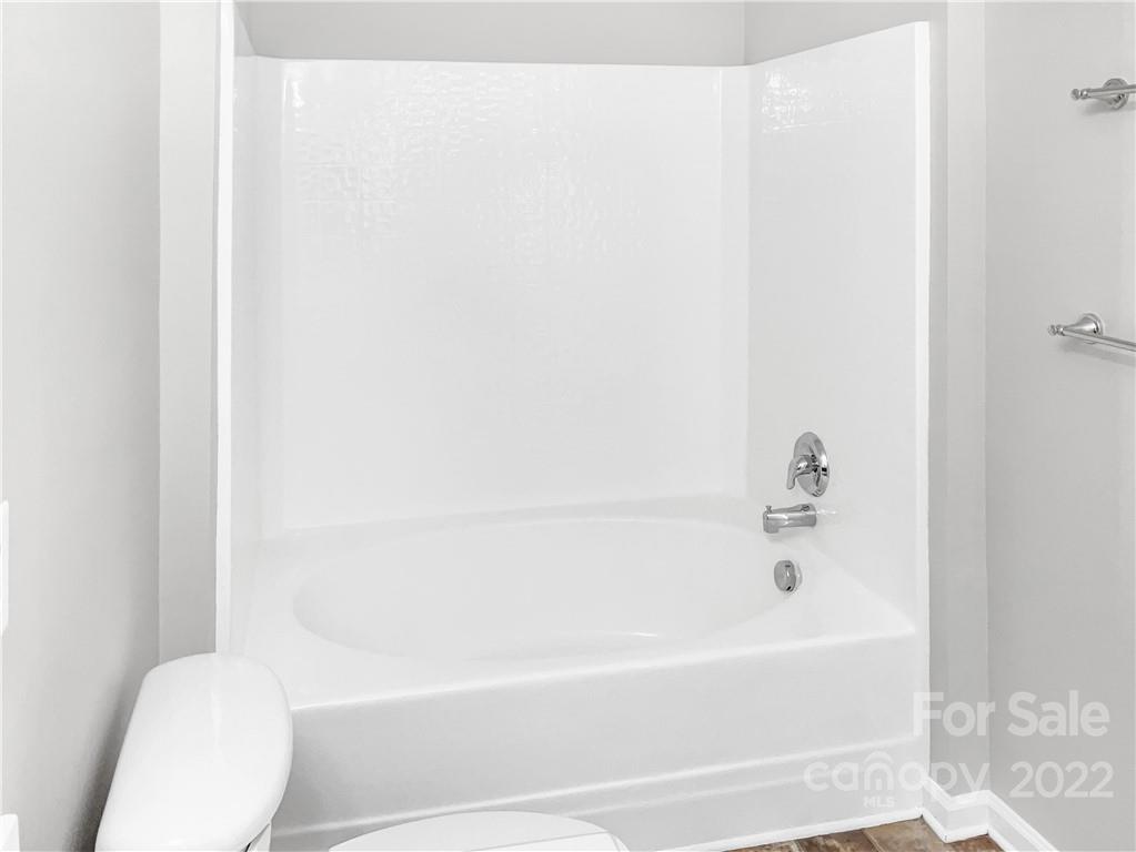 6156 Prosperity Church Road Charlotte, NC 28269 - Photo 25 of 31 a bathroom with a bathtub and a toilet