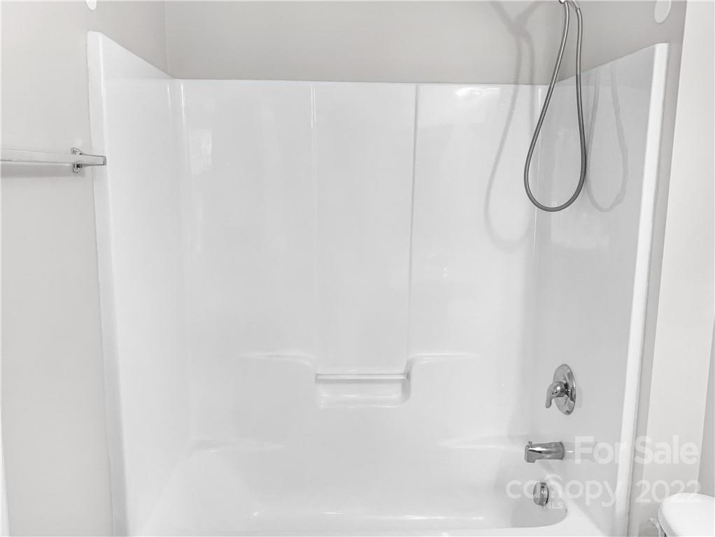 6156 Prosperity Church Road Charlotte, NC 28269 - Photo 31 of 31 a bathroom with a glass shower door