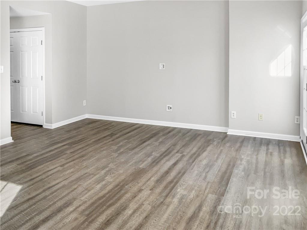 6156 Prosperity Church Road Charlotte, NC 28269 - Photo 4 of 31 a view of an empty room with wooden floor