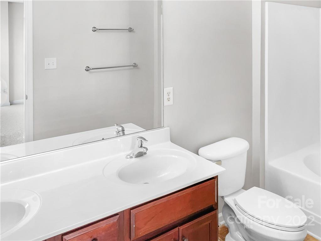 6156 Prosperity Church Road Charlotte, NC 28269 - Photo 6 of 31 a bathroom with a sink a toilet and shower