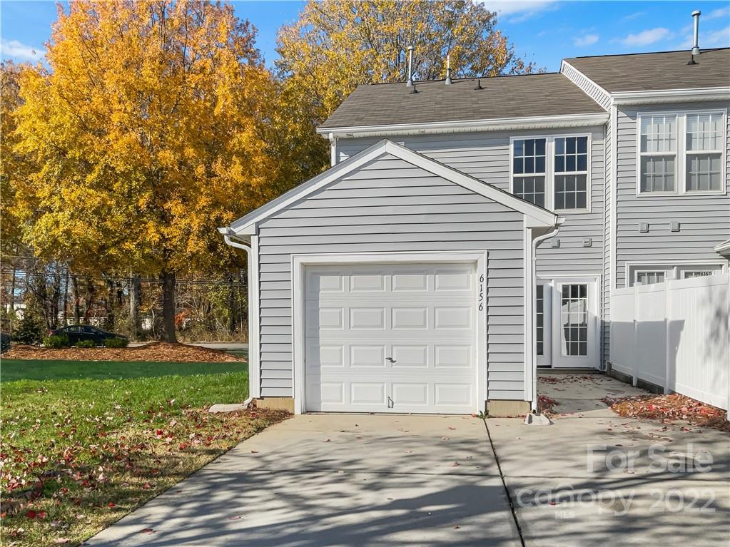 6156 Prosperity Church Road Charlotte, NC 28269 - Photo 7 of 31 a front view of a house with a yard