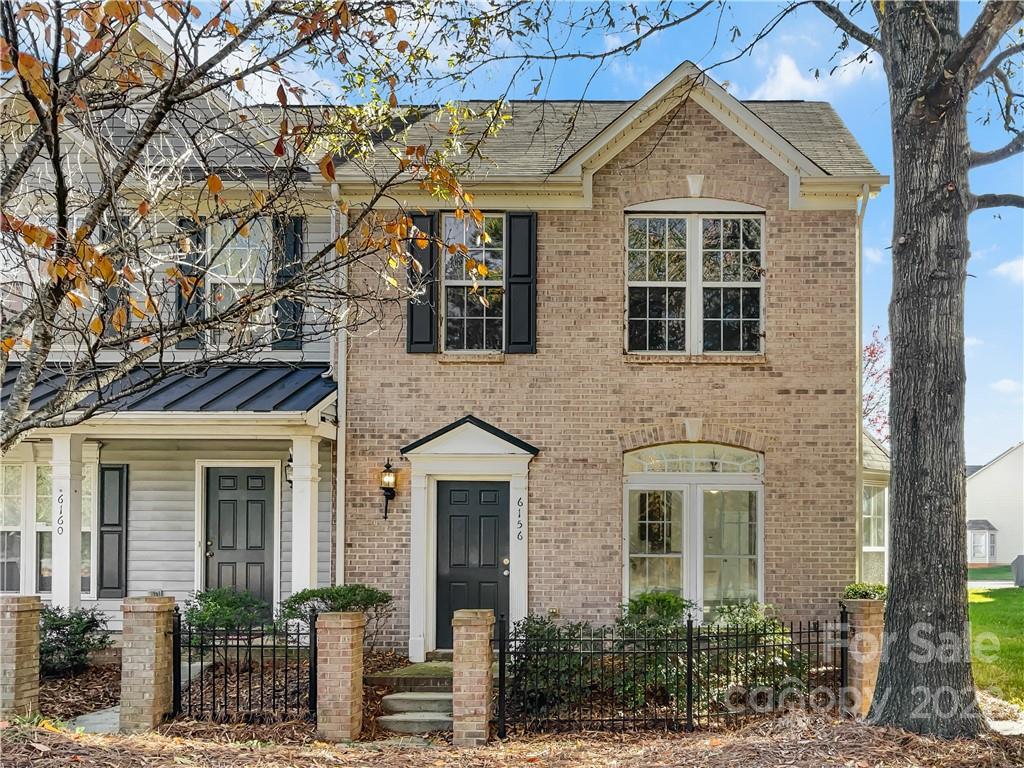 6156 Prosperity Church Road Charlotte, NC 28269 - Photo 8 of 31 front view of a brick house with a large windows