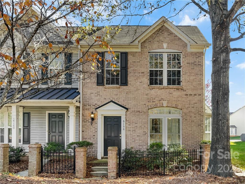 6156 Prosperity Church Road Charlotte, NC 28269 - Photo 9 of 31 front view of a brick house with a large windows