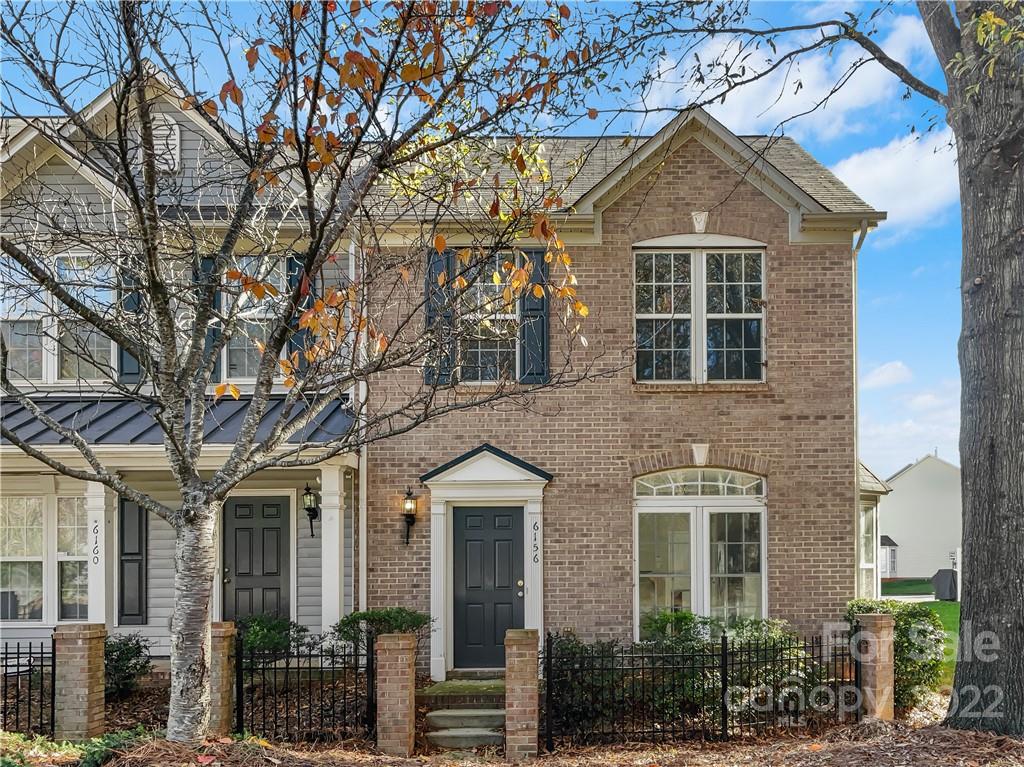 6156 Prosperity Church Road Charlotte, NC 28269 - Photo 10 of 31 front view of a brick house with a large windows