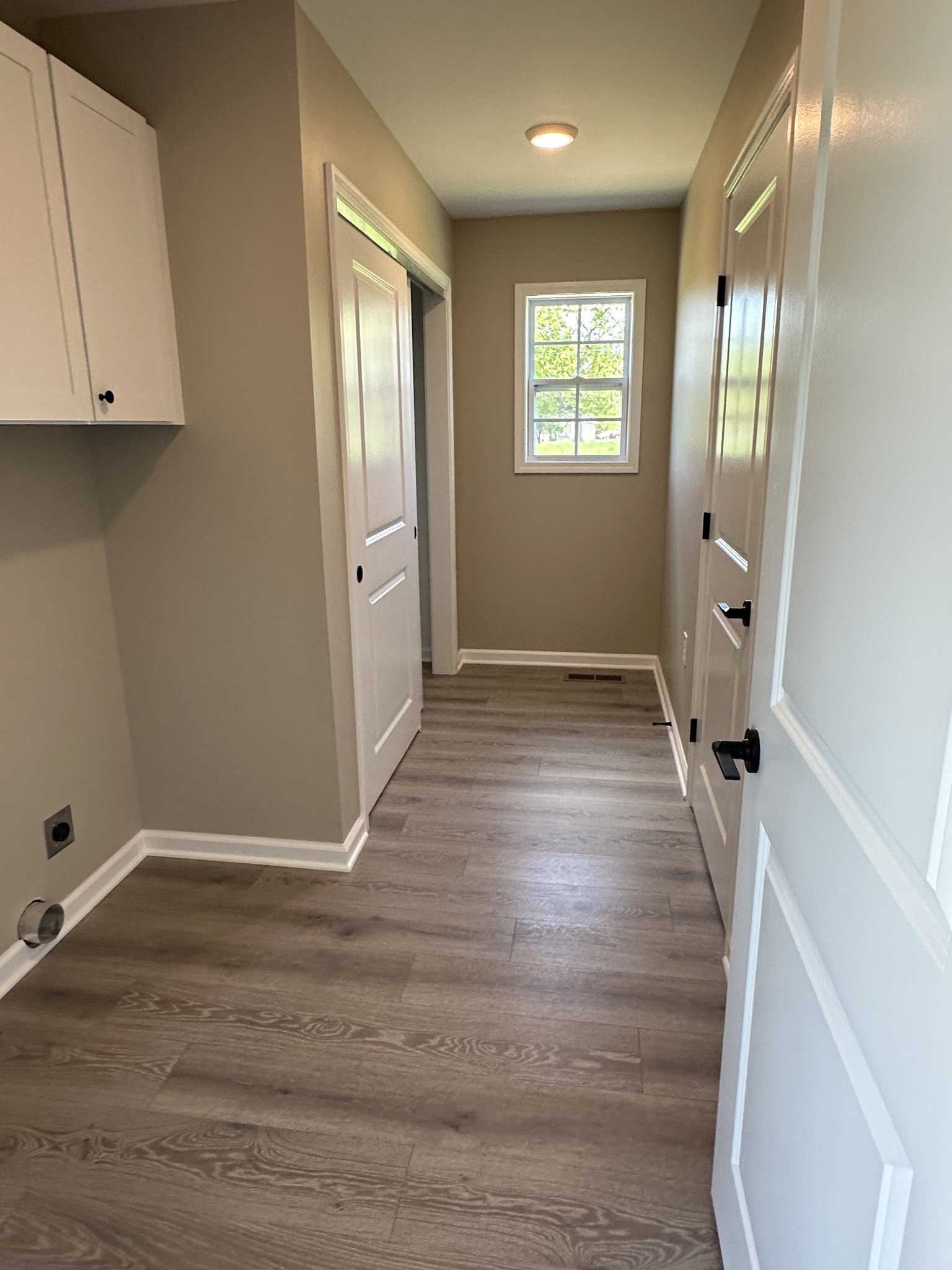 185 Rigling Road Loretto, TN 38469 - Photo 11 of 24 an empty room with wooden floor and a window