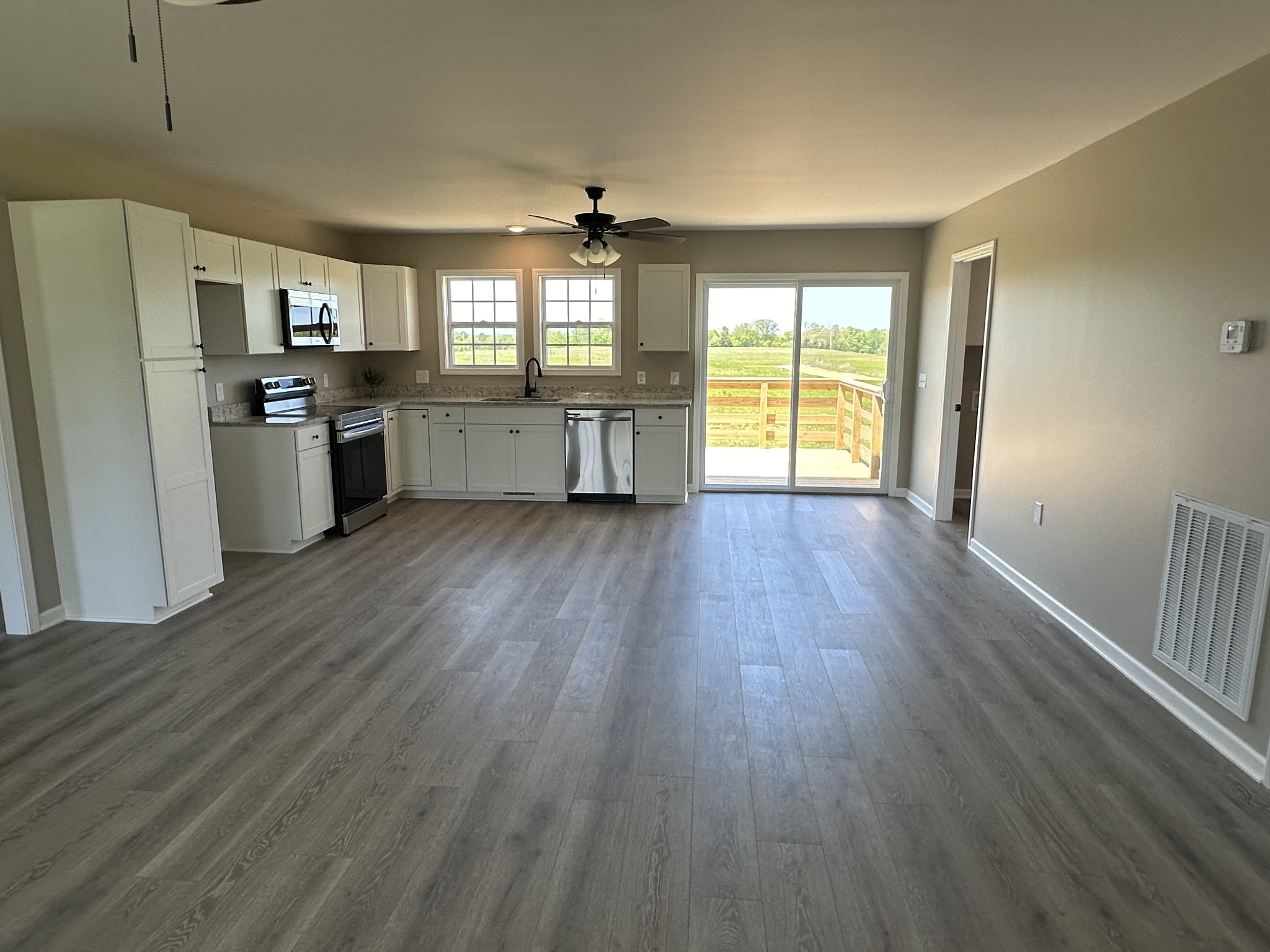 185 Rigling Road Loretto, TN 38469 - Photo 12 of 24 a view of a kitchen with refrigerator and wooden floor