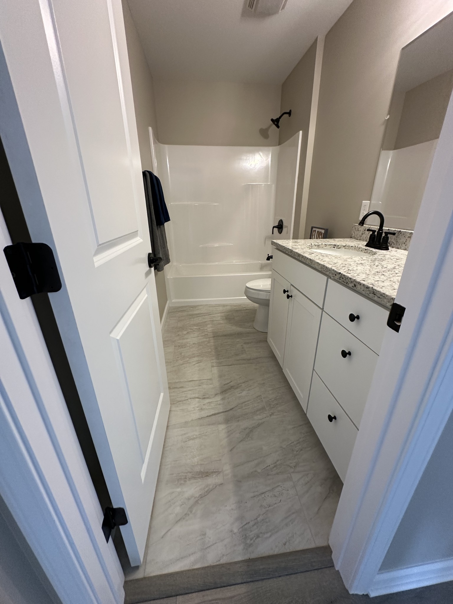 185 Rigling Road Loretto, TN 38469 - Photo 18 of 24 a bathroom with a double vanity sink and a mirror
