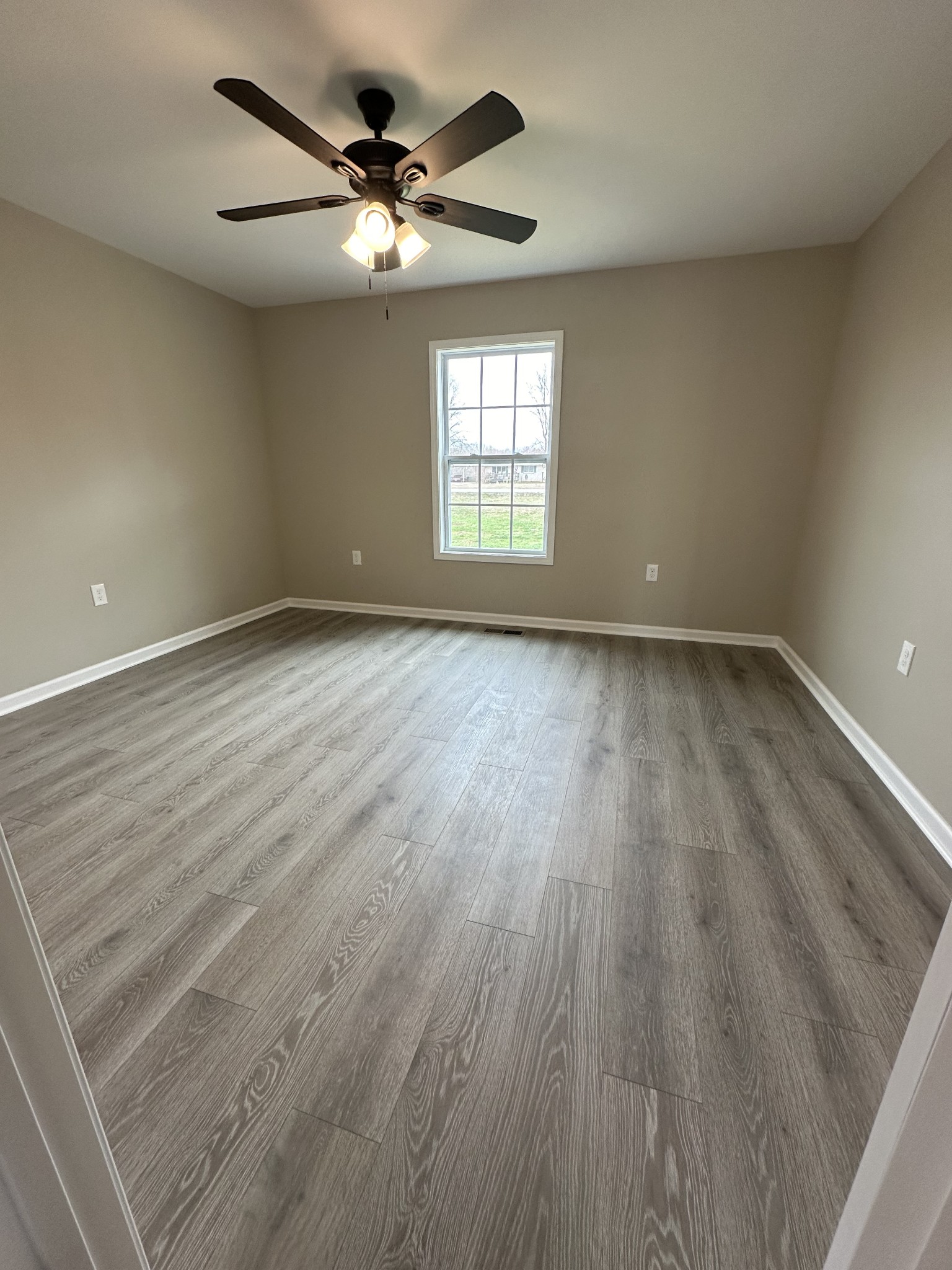 185 Rigling Road Loretto, TN 38469 - Photo 19 of 24 an empty room with wooden floor and windows