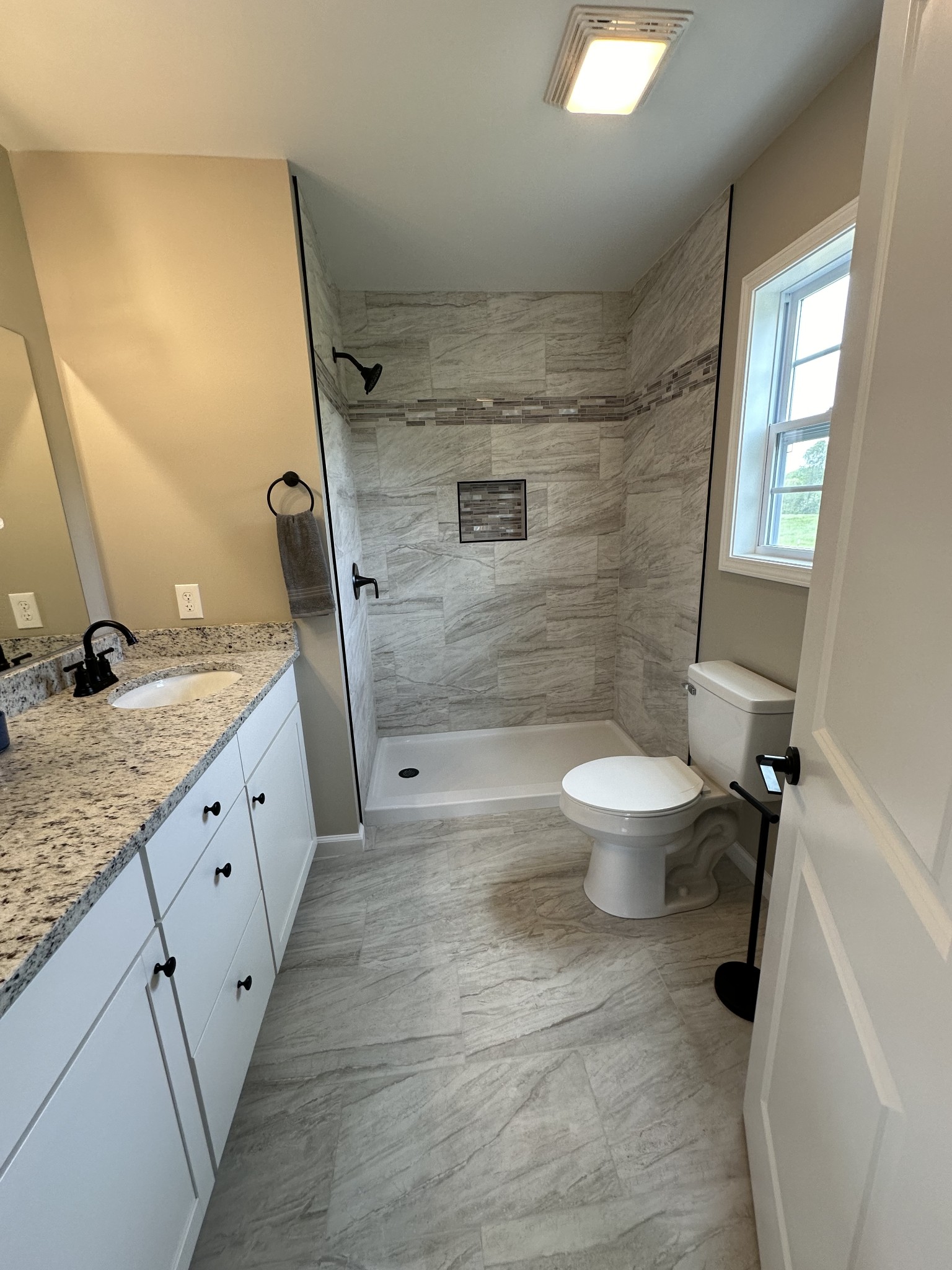 185 Rigling Road Loretto, TN 38469 - Photo 21 of 24 a bathroom with a granite countertop sink toilet and shower