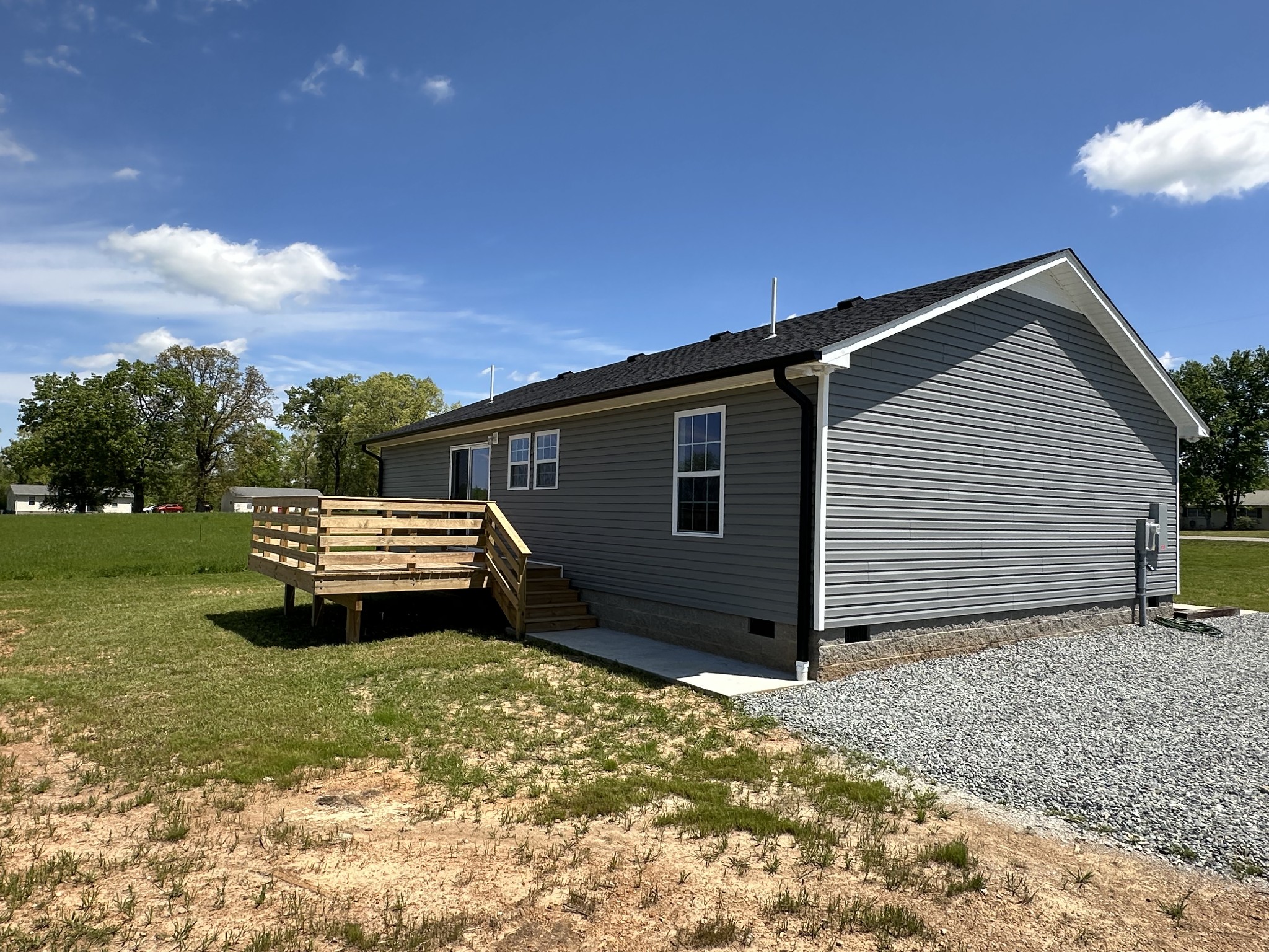185 Rigling Road Loretto, TN 38469 - Photo 5 of 24 a backyard of a house with a garden and deck