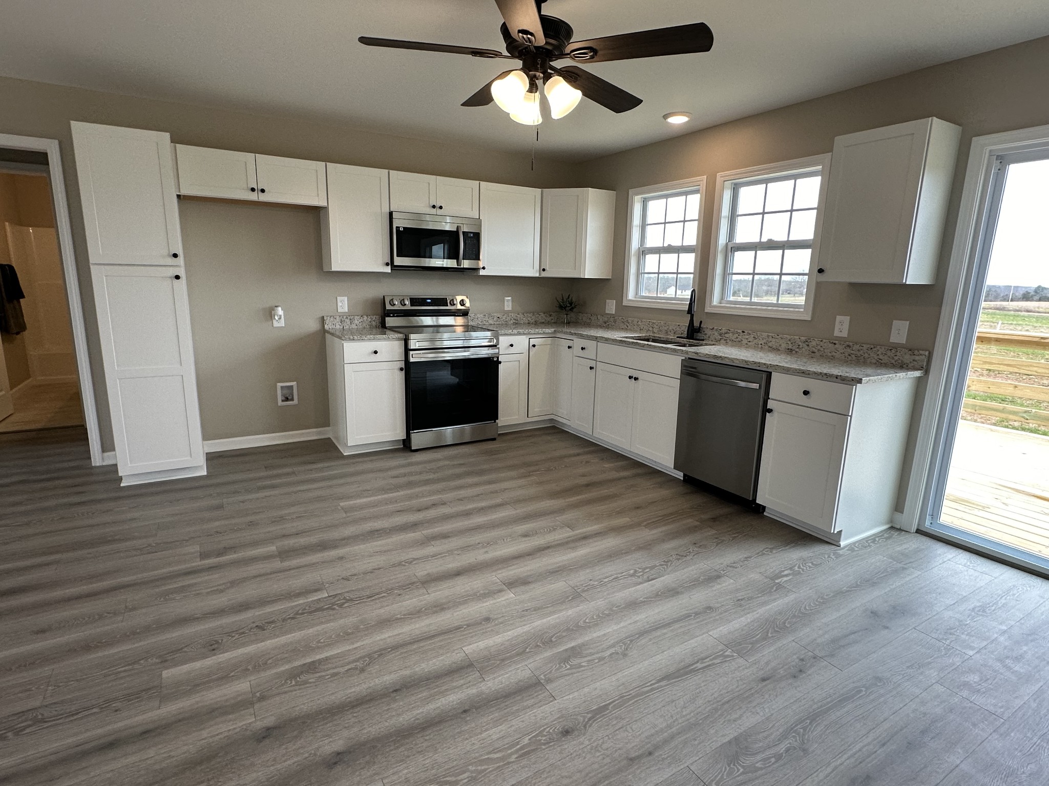 185 Rigling Road Loretto, TN 38469 - Photo 10 of 24 a large kitchen with stainless steel appliances granite countertop a stove a sink dishwasher and a refrigerator