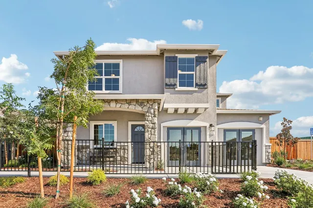 a front view of a house with a garden