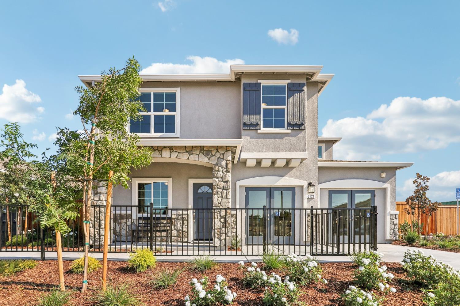a front view of a house with a garden
