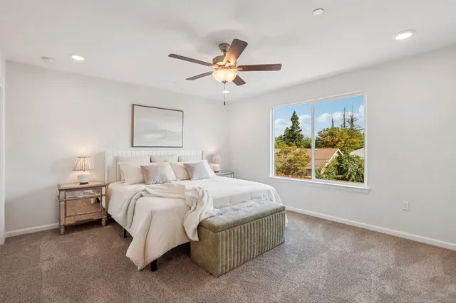 a spacious bedroom with a bed and a window