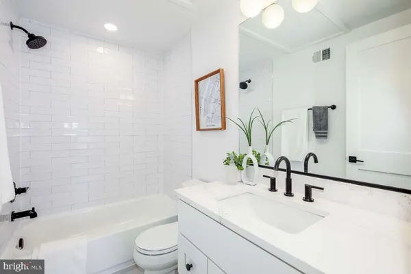 a bathroom with a sink a toilet and bathtub