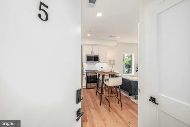 a view of a kitchen with dining table and chairs