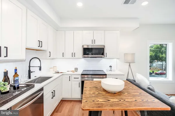 a kitchen with a sink a stove and cabinets