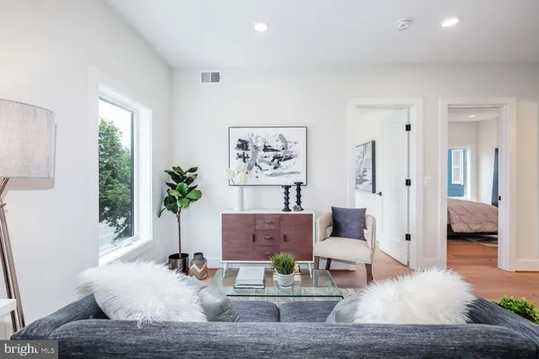 a living room with furniture and a potted plant