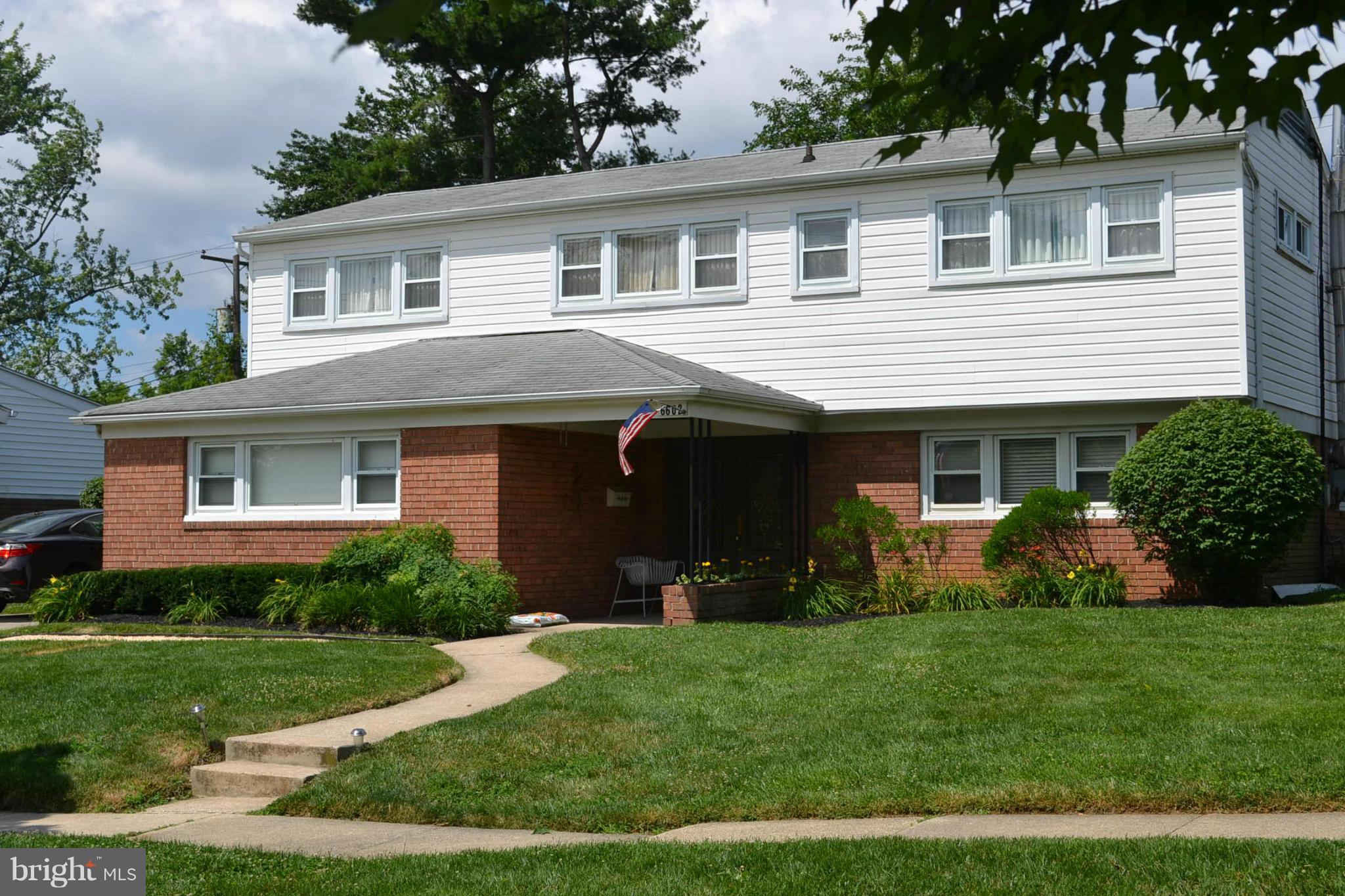 6602 Pimlico Road Baltimore, MD 21209 - Photo 1 of 23 a front view of a house with a garden and plants