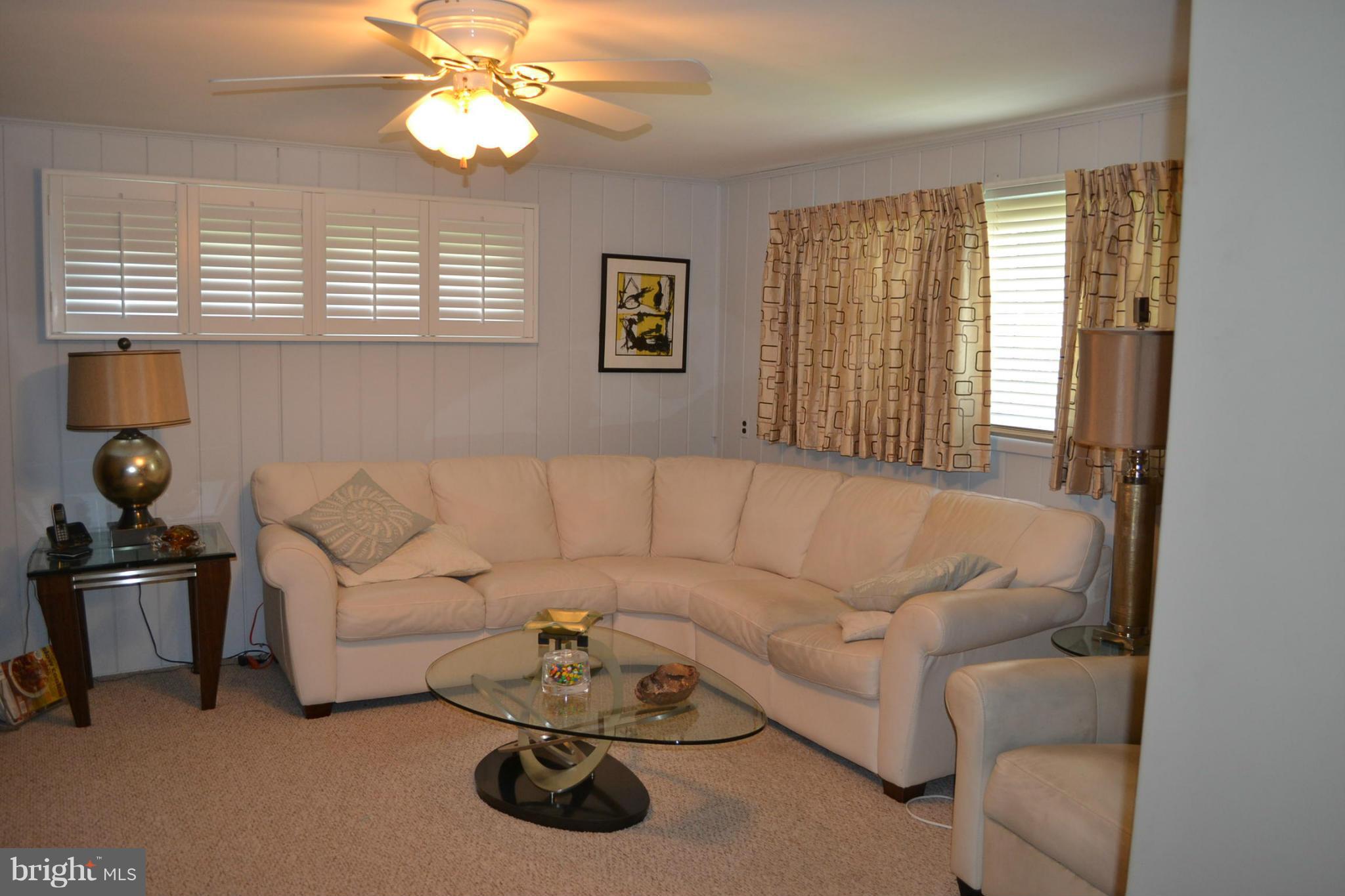 6602 Pimlico Road Baltimore, MD 21209 - Photo 8 of 23 a living room with furniture a chandelier and a window