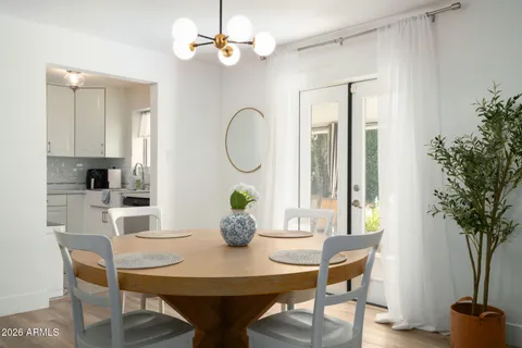 a view of a dining room with furniture and a potted plant