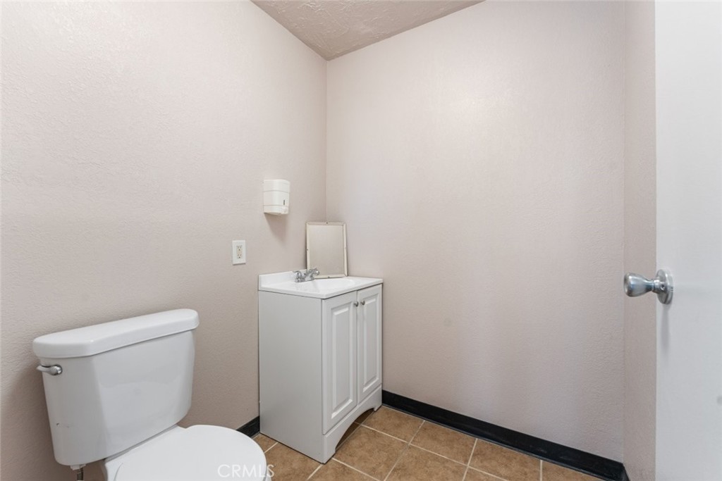 27157 Twenty Mule Team Road Boron, CA 93516 - Photo 14 of 32 a white toilet sitting next to a bathroom sink