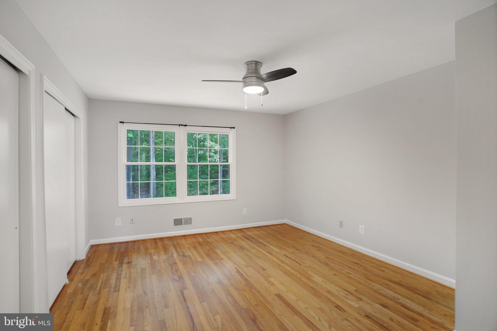 5925 Minutemen Road, Unit 248 Springfield, VA 22152 - Photo 16 of 26 Hardwood floor in primary bedroom, back to woods