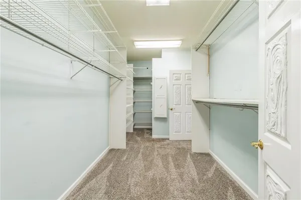 a view of hallway with stairs and wooden floor