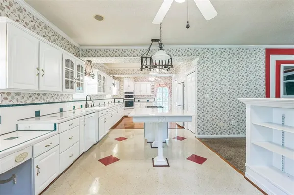 a spacious bathroom with a granite countertop sink a mirror and a shower
