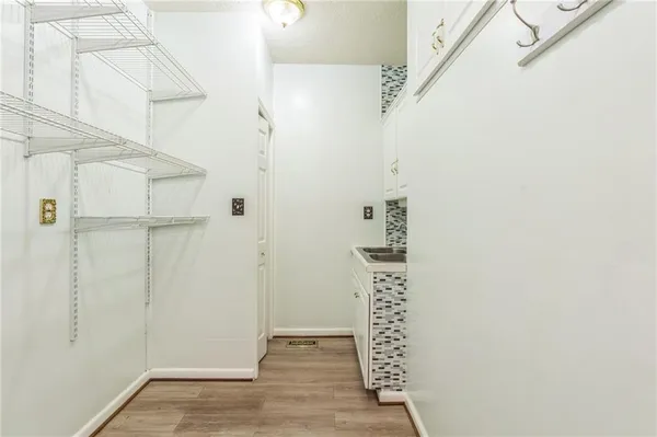 an empty room with fan and windows