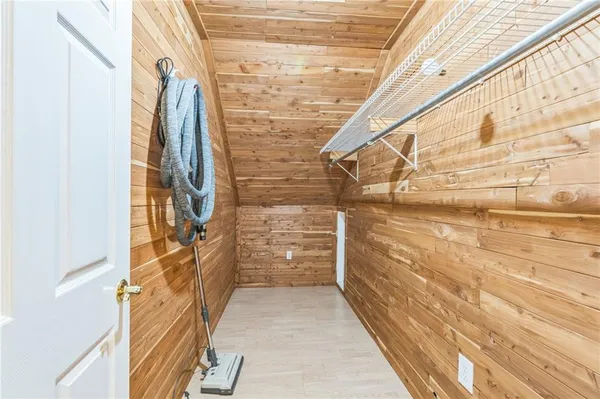 a view of a room with wooden walls