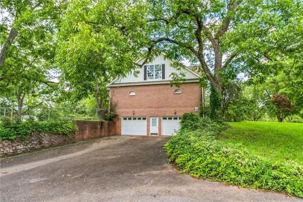 a view of a park with large trees