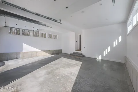 a bedroom with a bed chair and window