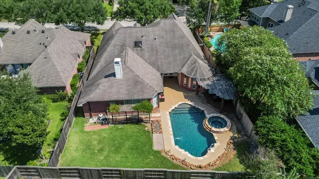 an aerial view of residential house with outdoor space and swimming pool