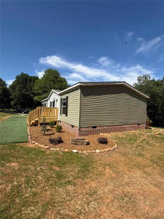 2606 Whipporwill Road Royston, GA 30662 - Photo 2 of 30 a backyard of a house with table and chairs