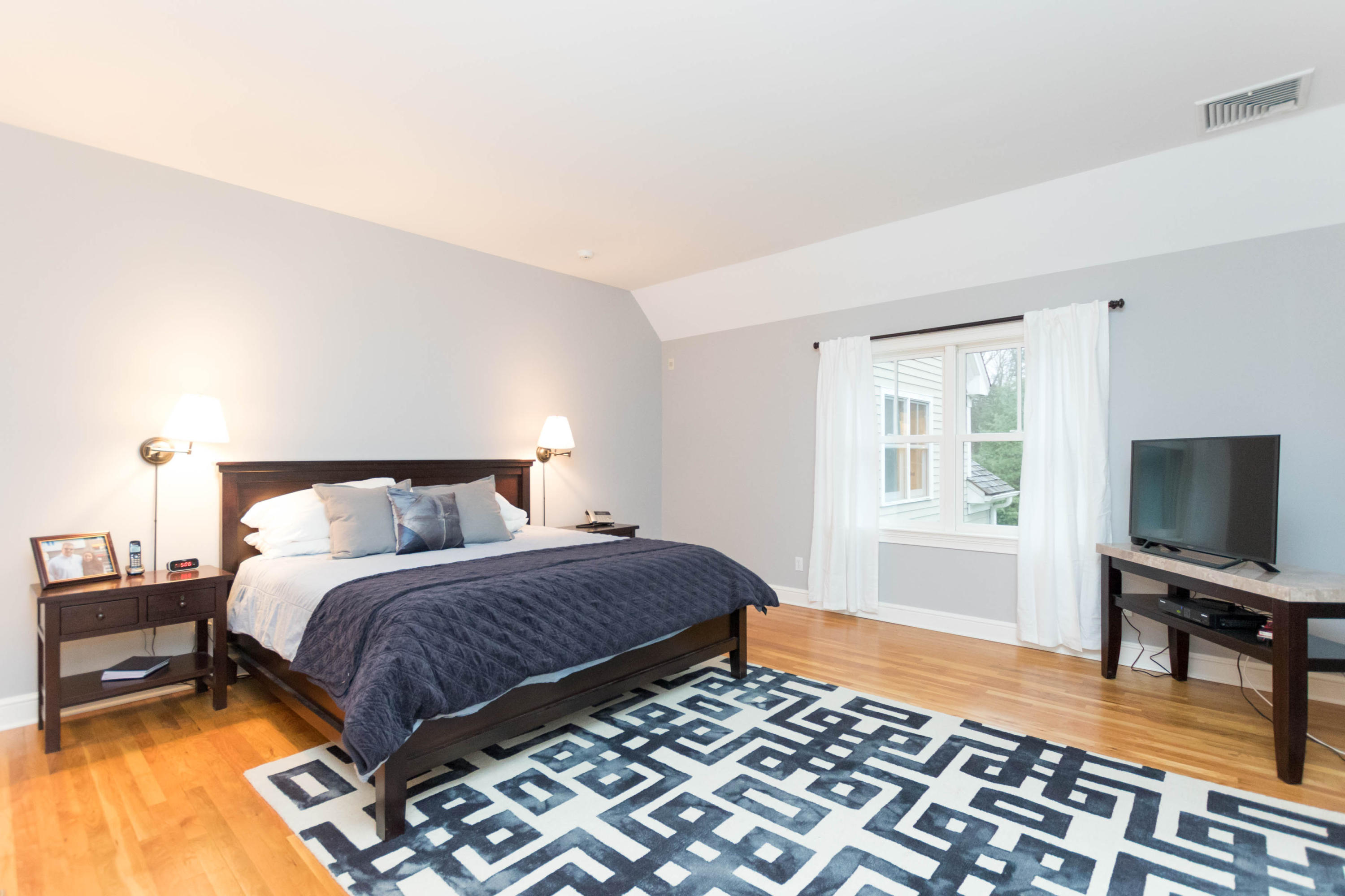 75 Colonial Road New Canaan, CT 06840 - Photo 22 of 49 a bedroom with a bed and a flat screen tv