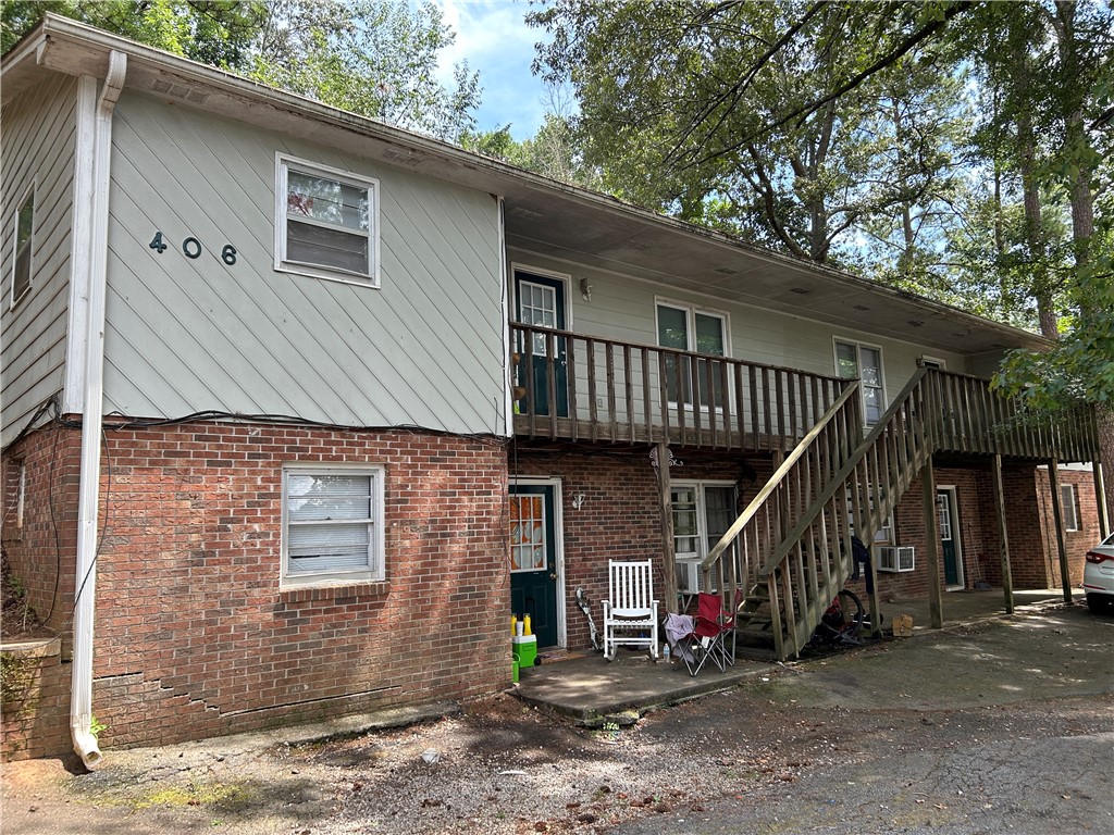 406 Old Central Road, Unit 1 Clemson, SC 29631 - Photo 1 of 8 This multi-story dwelling features a harmonious blend of brick and siding, nestled among mature trees.
