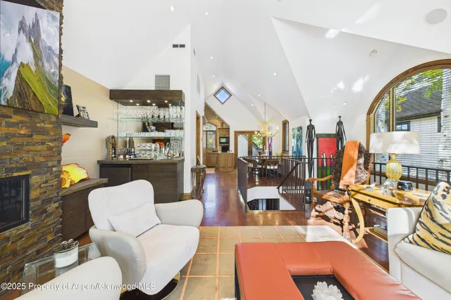 a living room with patio furniture and a fireplace