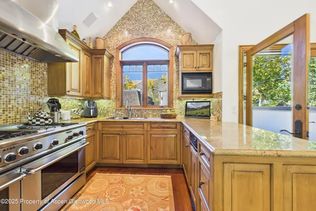 a kitchen with a stove a sink and a refrigerator
