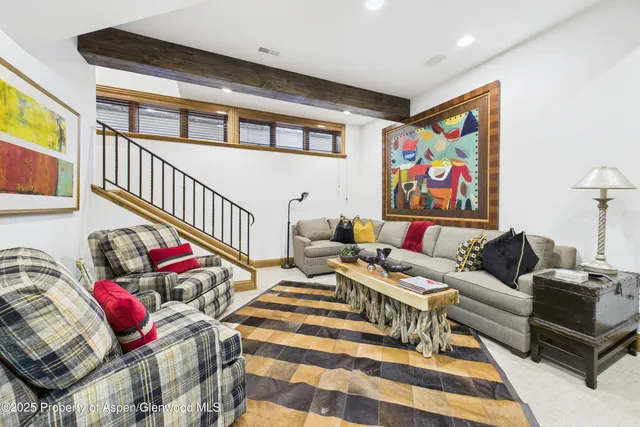 a living room with furniture and painting on the wall