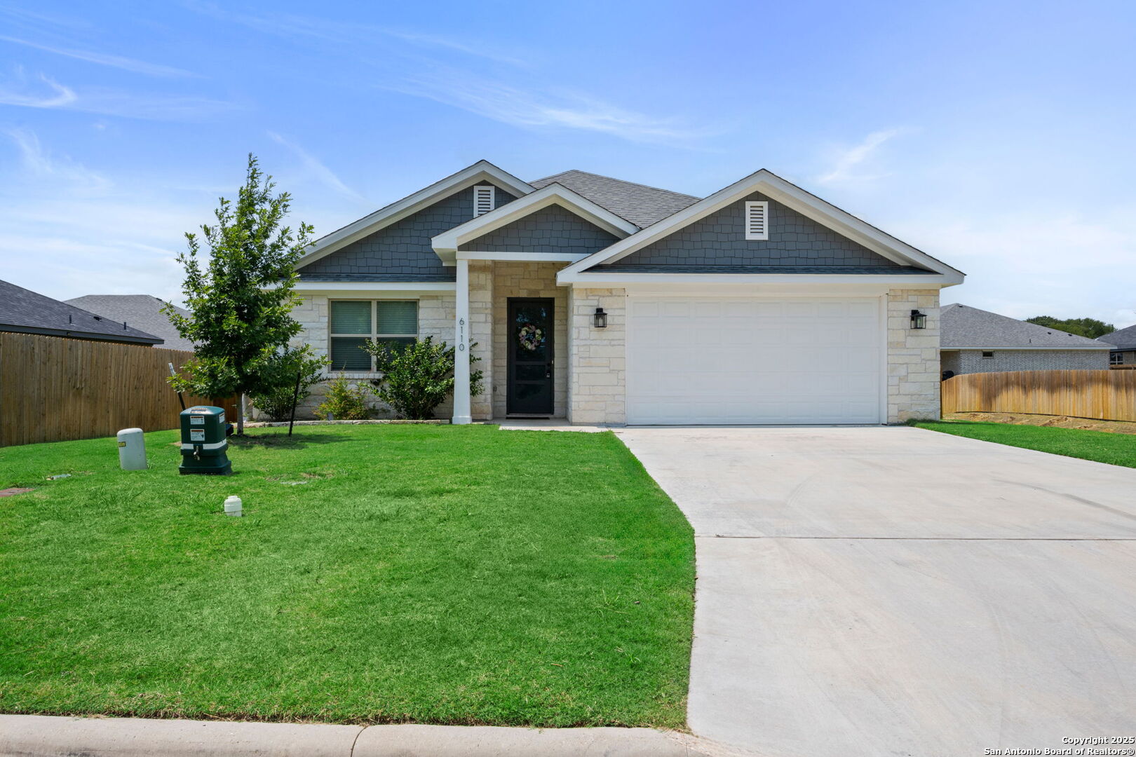 a front view of house with yard and green space