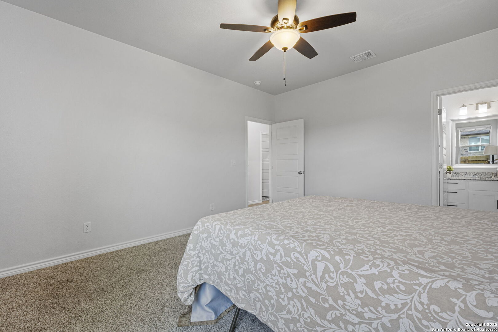 6110 Salerno Street Temple, TX 76502 - Photo 33 of 44 a bedroom with a bed and a chandelier