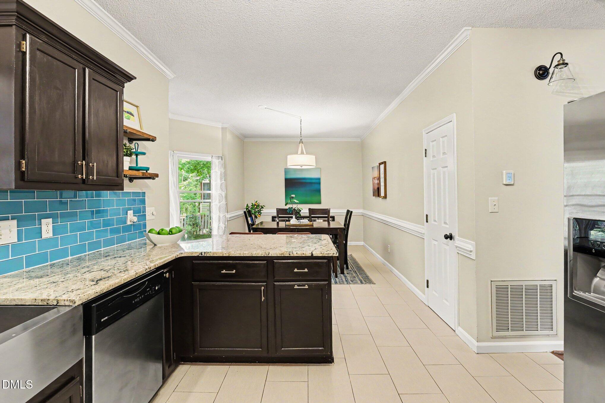 5468 Ingate Way Raleigh, NC 27613 - Photo 6 of 24 a kitchen with a sink and cabinets