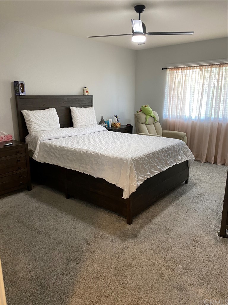 28950 Pebble Beach Drive Menifee, CA 92586 - Photo 11 of 18 a bedroom with a bed and window