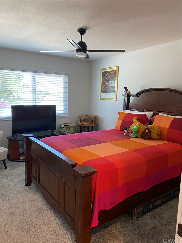 28950 Pebble Beach Drive Menifee, CA 92586 - Photo 13 of 18 a bedroom with a bed and a flat screen tv