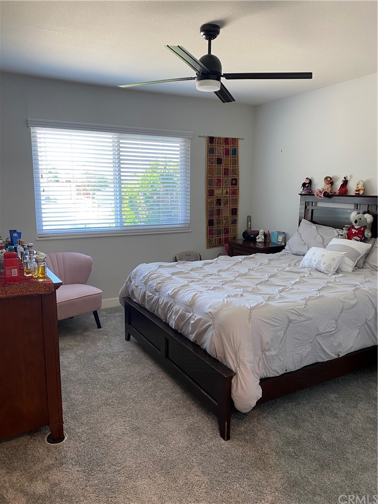 28950 Pebble Beach Drive Menifee, CA 92586 - Photo 14 of 18 a bedroom with a bed and a window