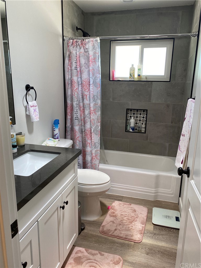 28950 Pebble Beach Drive Menifee, CA 92586 - Photo 15 of 18 a bathroom with a sink a toilet and a bathtub