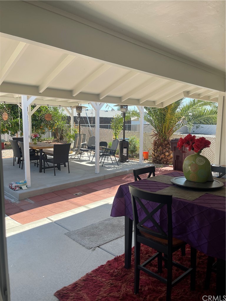 28950 Pebble Beach Drive Menifee, CA 92586 - Photo 16 of 18 a dining room with furniture and a large window