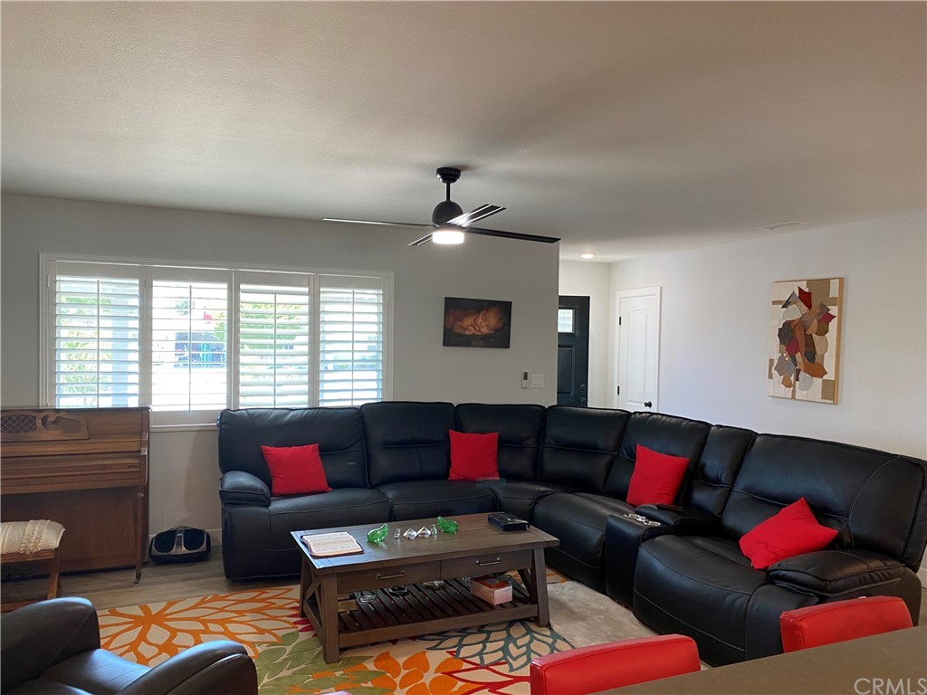 28950 Pebble Beach Drive Menifee, CA 92586 - Photo 8 of 18 a living room with furniture and a large window